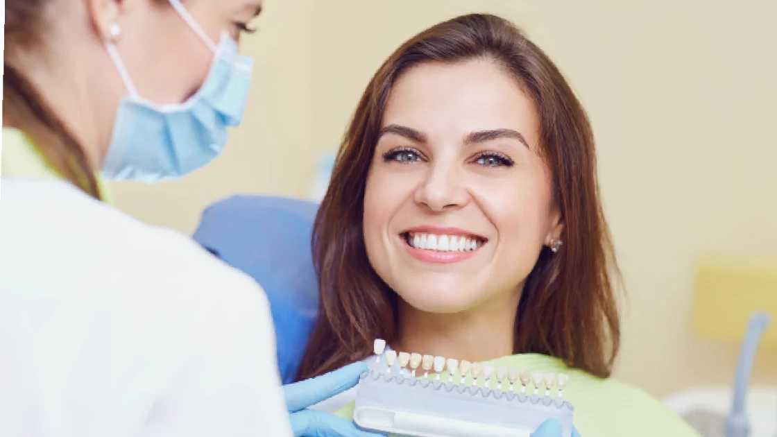 Smiling woman in a dental chair during a dental crown in Annapolis, MD