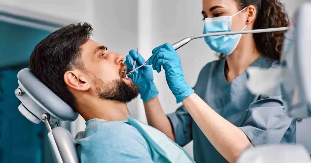 Patient receiving dental care from a dentist, demonstrating Root Canal vs Dental Crown options for repairing damaged teeth