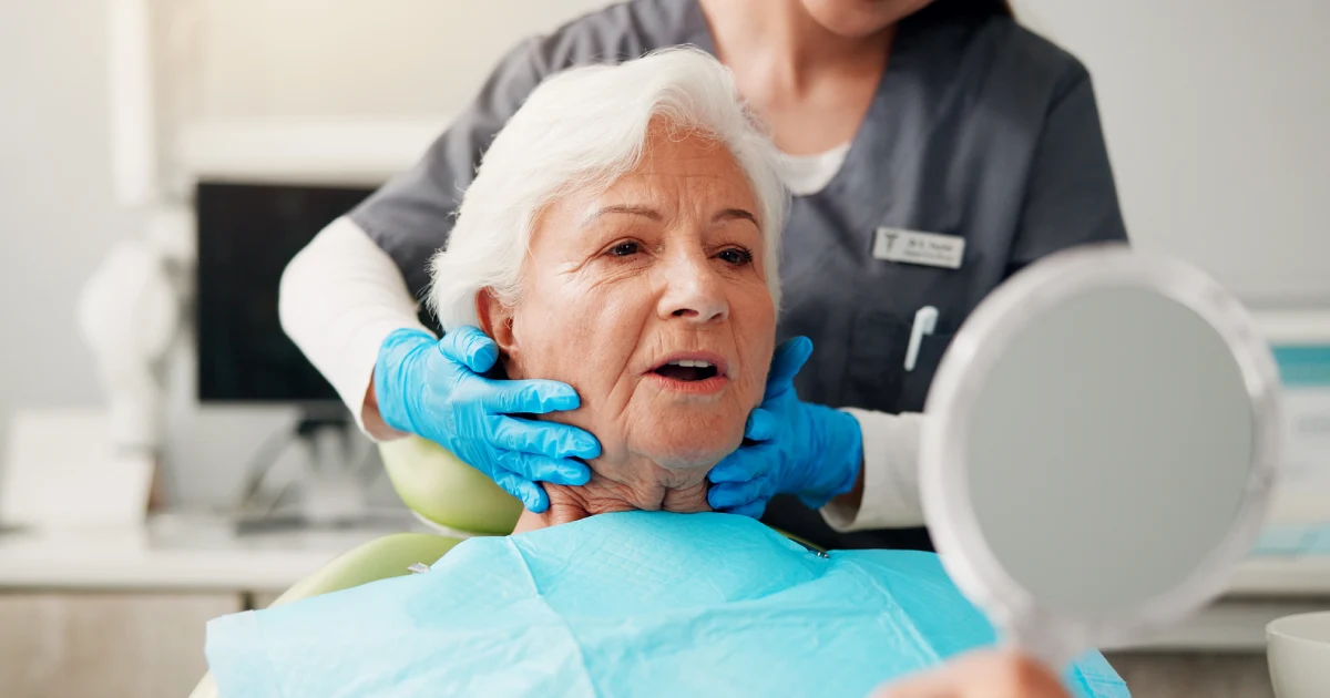 Woman receiving a dental checkup to prevent gum disease and reduce need for periodontal therapy